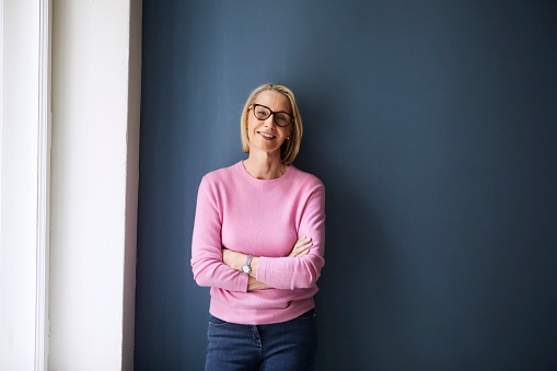 Woman standing against a wall