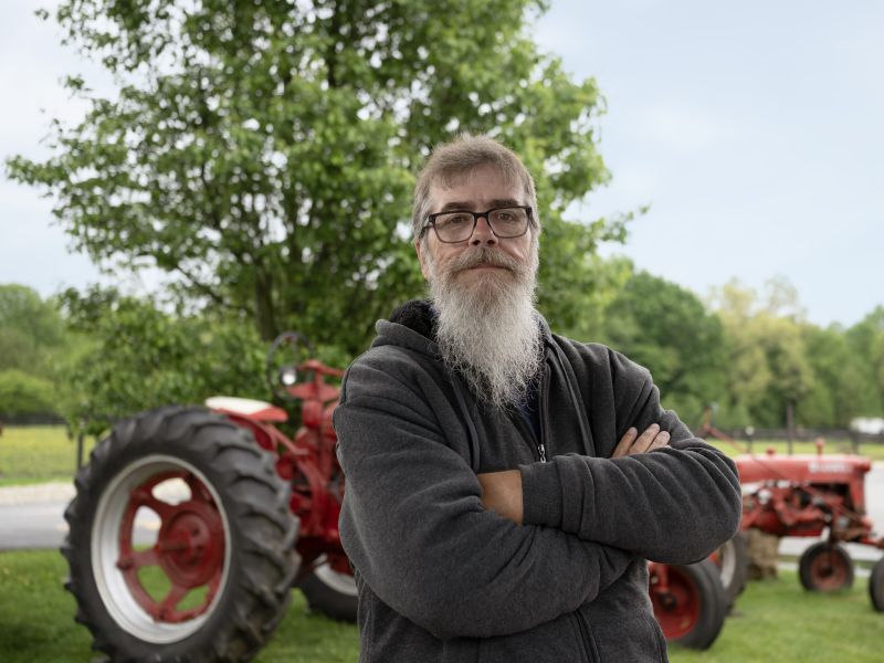 Kevin in front of farm equipment