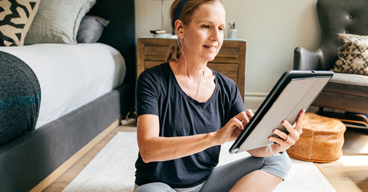 Woman doing exercise with an ipad
