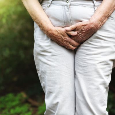 Woman clutching her crotch