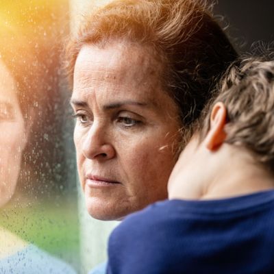Woman in thought holding child