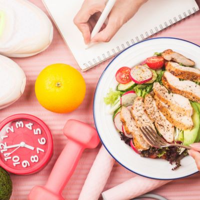 Plate of food with woman writing