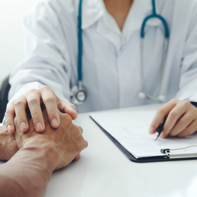 Doctor hands holding patients' hands for encouragement and empathy