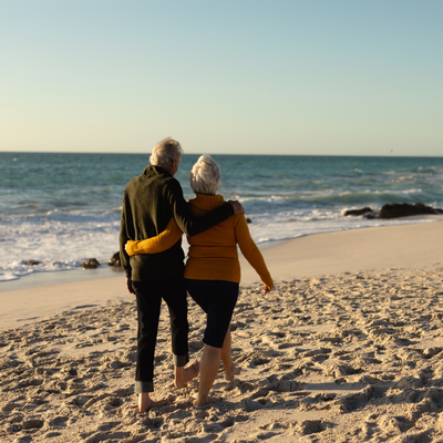happy couple walking on beach