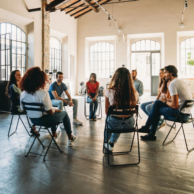 Group therapy session with people talking together