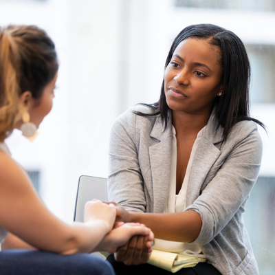 Therapist offering support and understanding to individuals in a counseling session