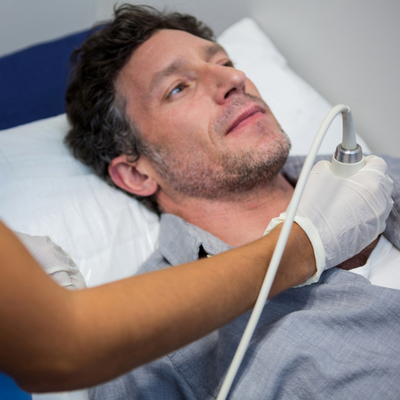 Doctors performing a doppler sonography on patient