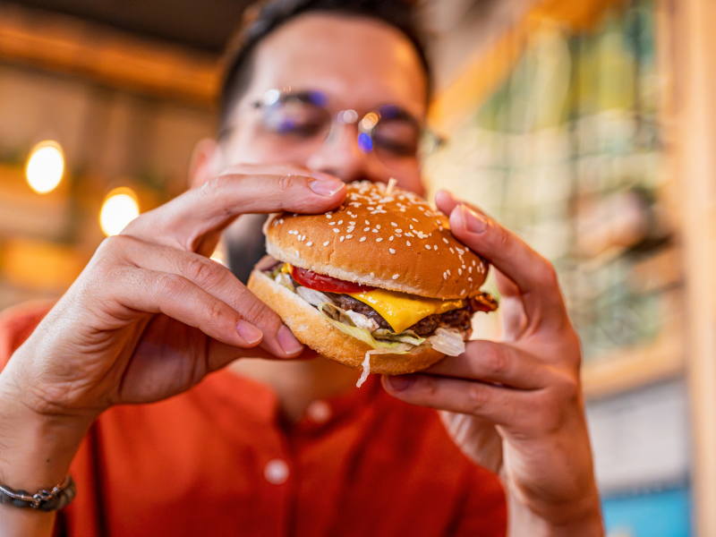 Young man eating a tasty burger