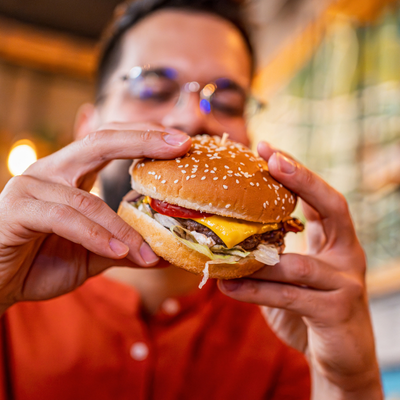 Young man eating a tasty burger