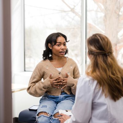 A young woman talking to her doctor