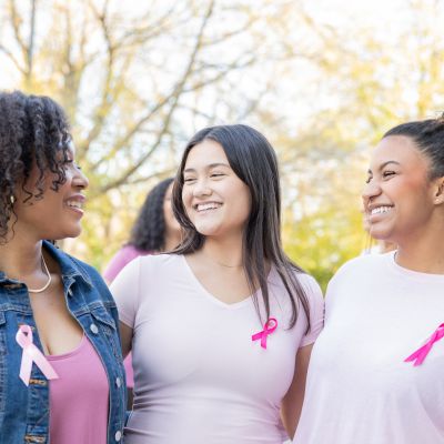 A group of women wearing pink ribbons for breast cancer awareness