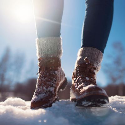 A person walking through snow in boots
