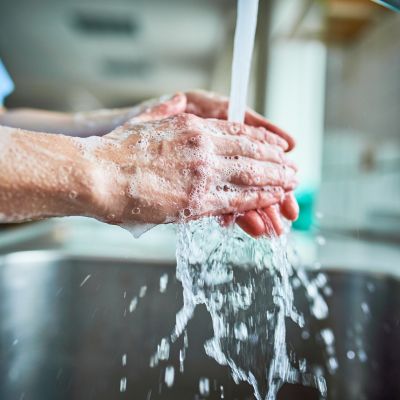 A person washing their hands with soap and water