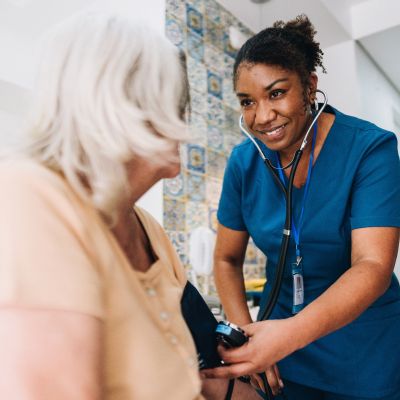 A nurse taking the blood pressure of a patient