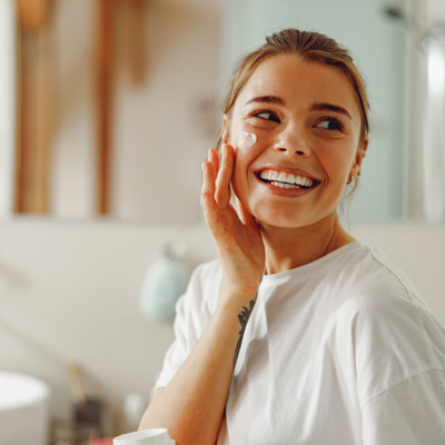 woman applying sunscreen to her face