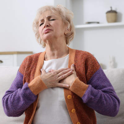 Woman clutching chest in pain