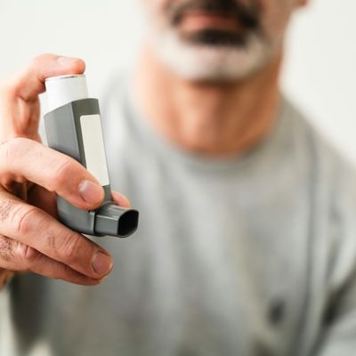 man holding an inhaler 