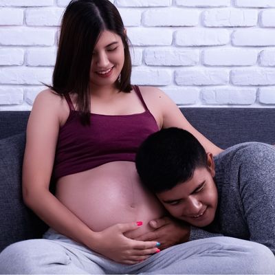mother and father hugging pregnant belly
