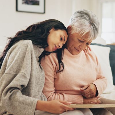 A younger woman comforting an older, sad woman