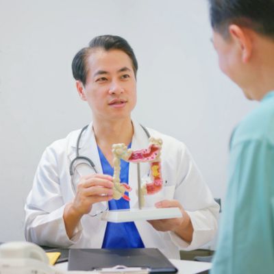A doctor explaining the digestive system to a patient