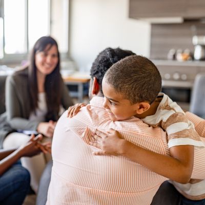 family gathered together with a child hugging an adult