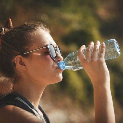 Woman drinking water outside