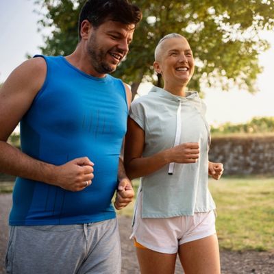 A man and woman jog together.