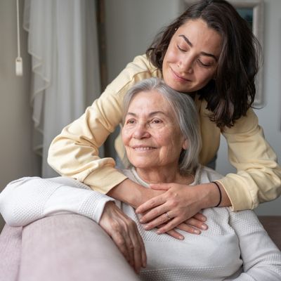 Adult daughter hugging elderly mother