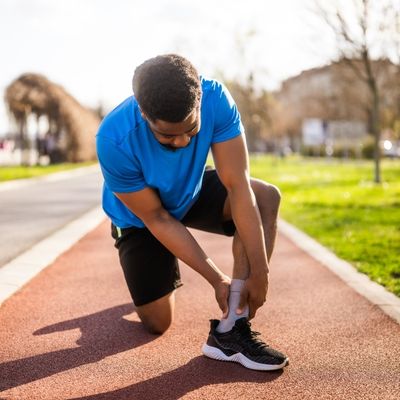 Man holding ankle