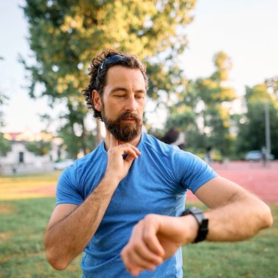 Man checking heart rate while exercising