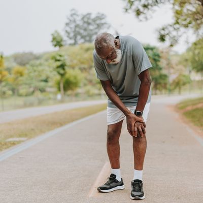 Man holding knee in pain