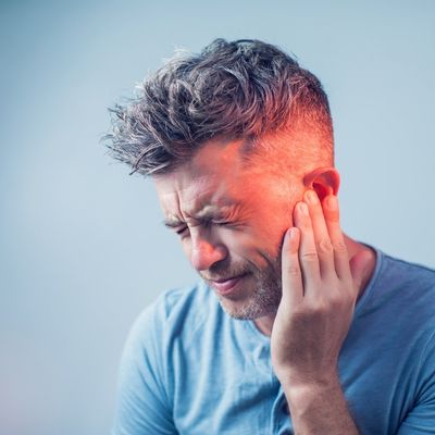 Man holding ear in pain