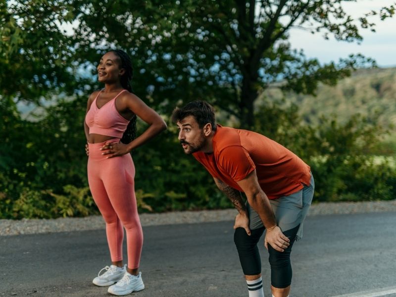 Woman and tired man running