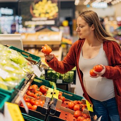 Pregnant woman shopping for produce
