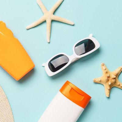 Sunscreen bottles, sunglasses, starfish, summer hat