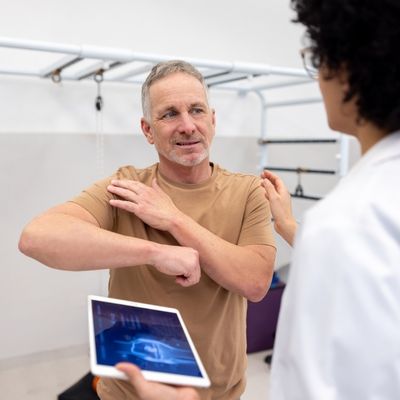 Patient showing doctor location of shoulder pain