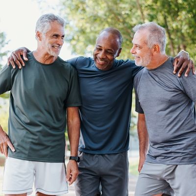 Three older men walking together