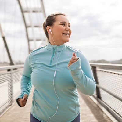 Woman smiling while running outside
