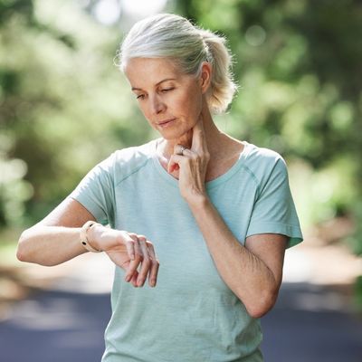 Older woman checking pulse while exercising