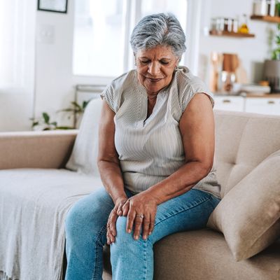 Older woman holding knee in pain