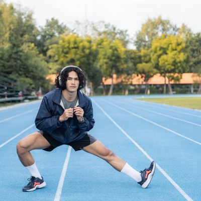 Man stretching on race track