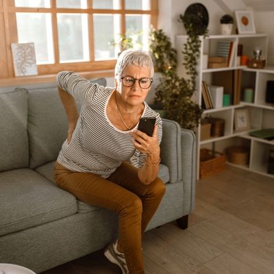 Older woman holding lower back