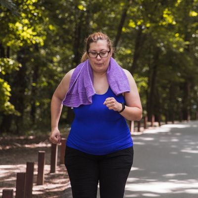 Woman running with towel around neck