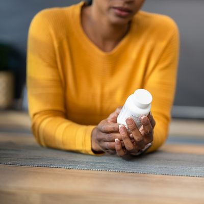 Woman reading medication bottle