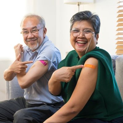 Older couple pointing to upper arm