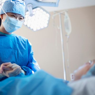 Clinical Staff holding patients hand in surgery