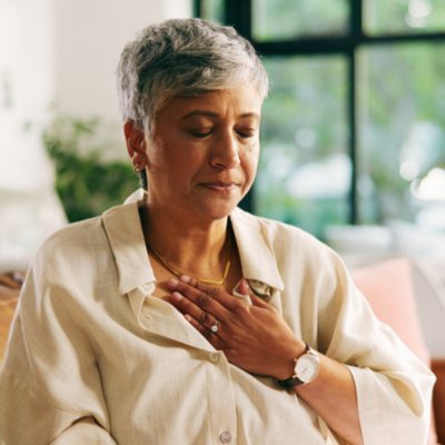 Woman with hand on her chest