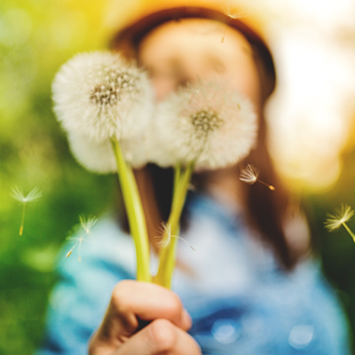 Woman holding dandelions