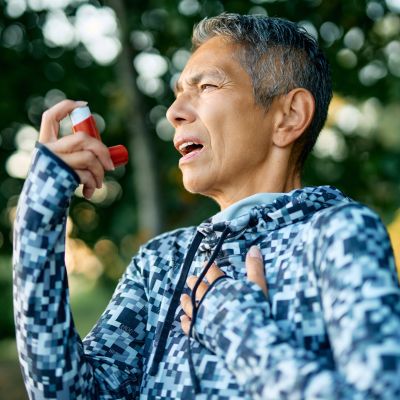 woman with inhaler outdoors
