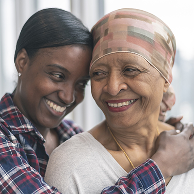 Young woman and older woman share embrace